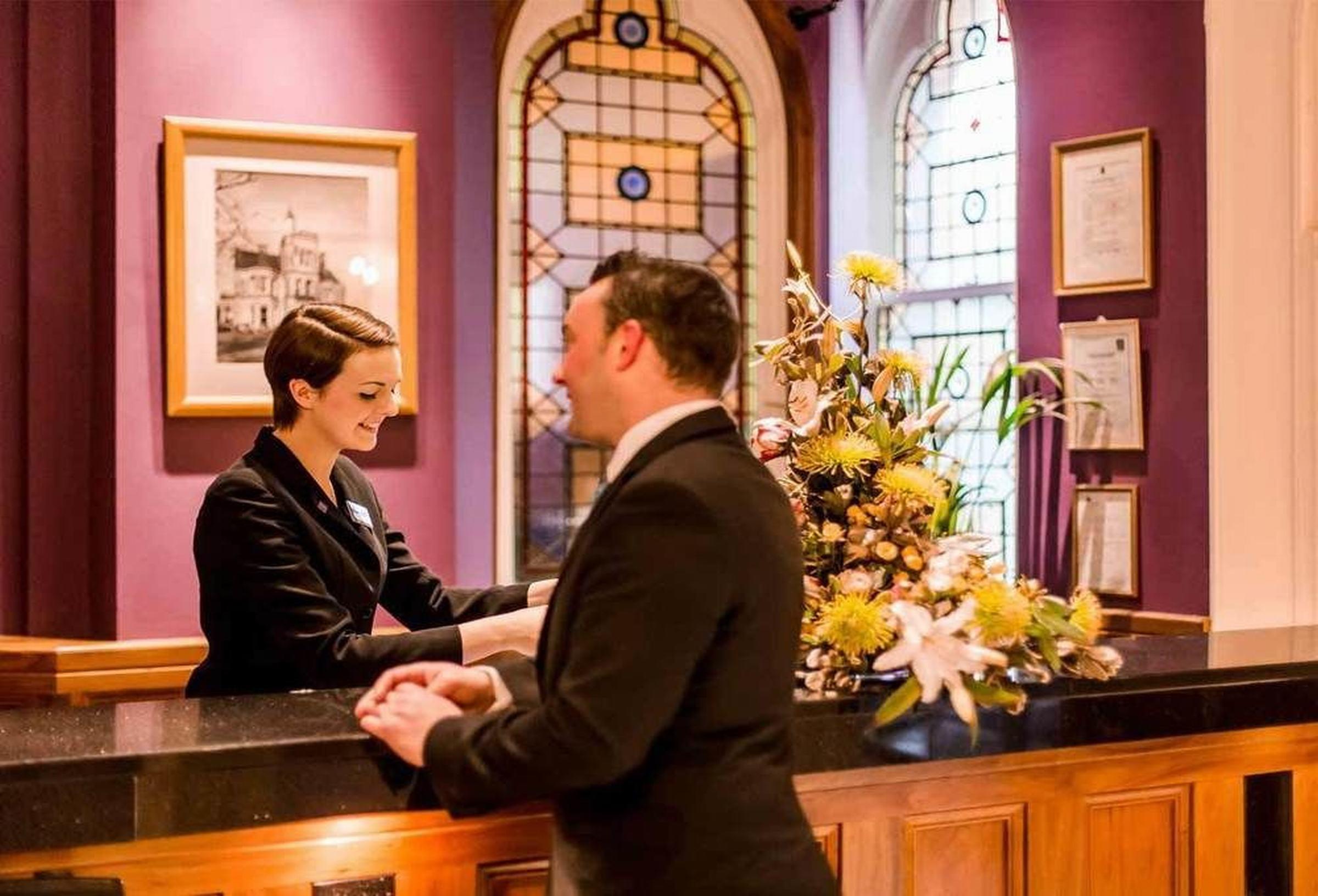 The Culloden Estate And Spa Holywood  Εξωτερικό φωτογραφία A hotel receptionist at work